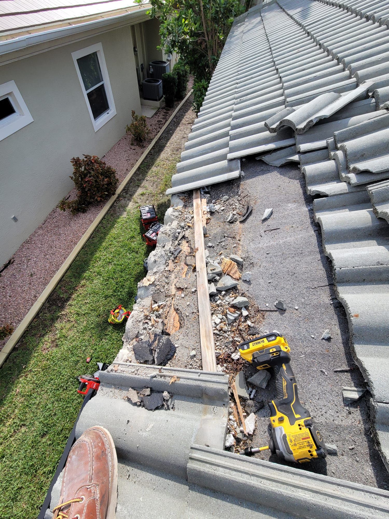 Tools and removed tiles staged for roof repairs, Big Texas Roofing and Solar