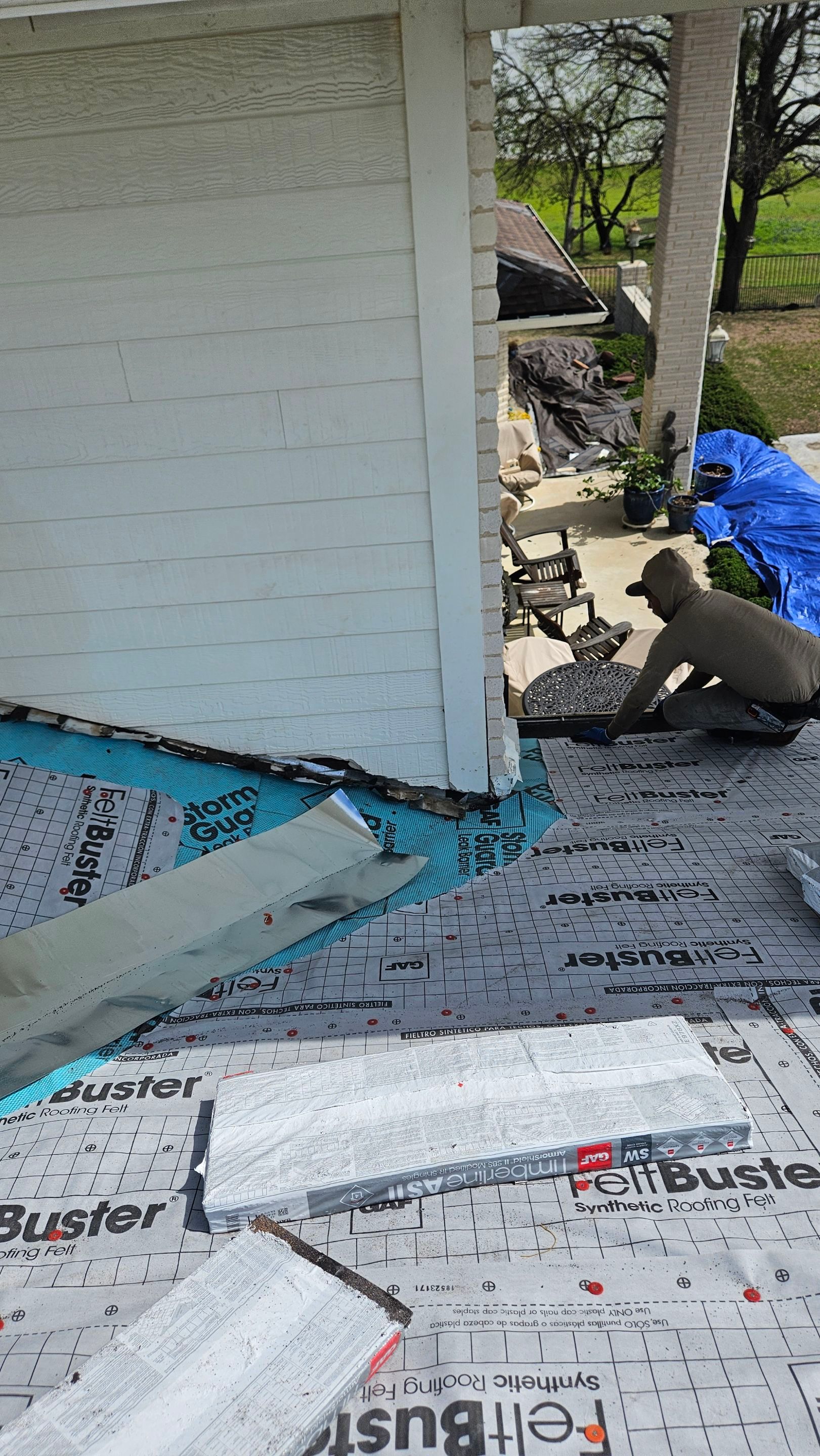 Roof repair detail beside an exterior wall, Big Texas Roofing and Solar