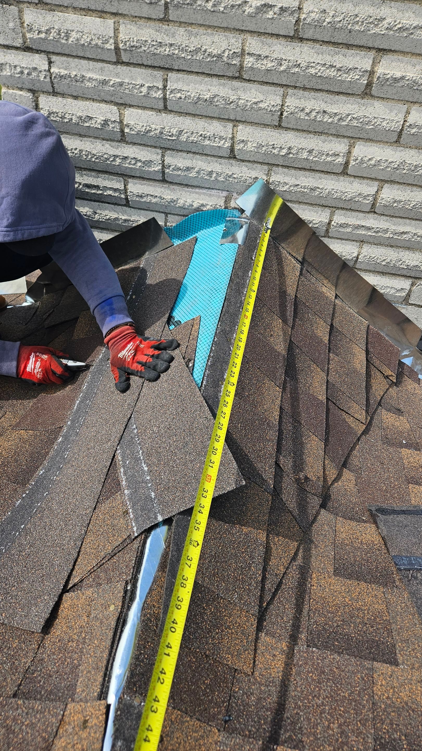 Crew repairing roof flashing beside a chimney, Big Texas Roofing and Solar