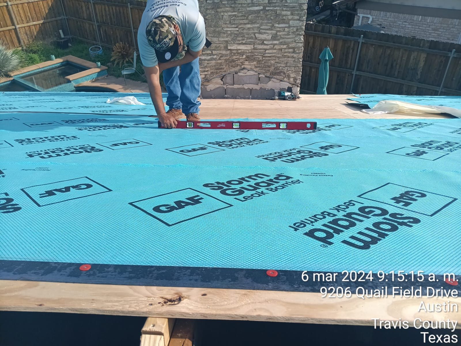 Crew working on roof decking near a chimney, Big Texas Roofing and Solar