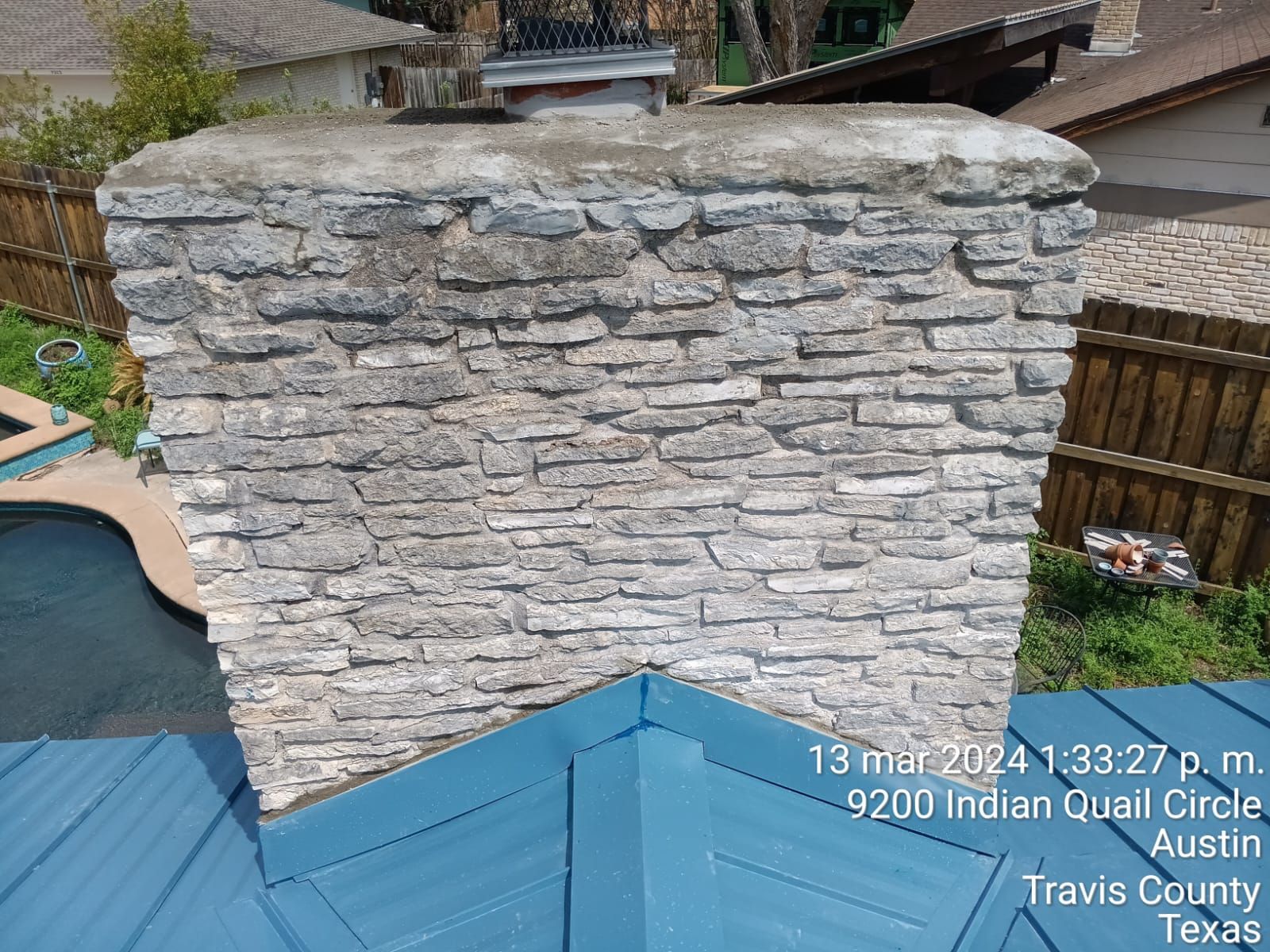 Chimney flashing beside a metal roof, Big Texas Roofing and Solar