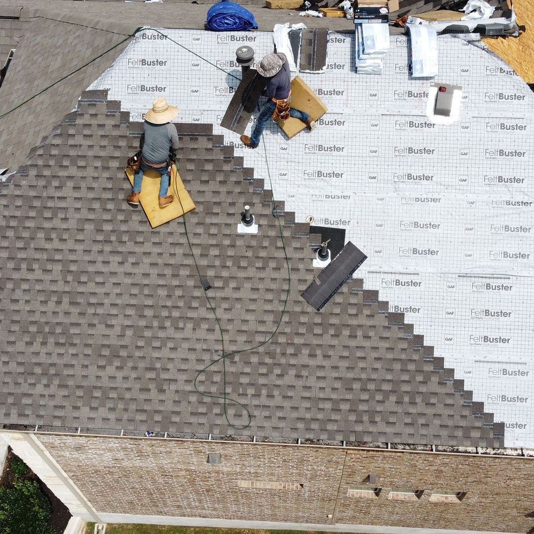 Roofing crew installing architectural shingles over GAF underlayment from the Big Texas job gallery