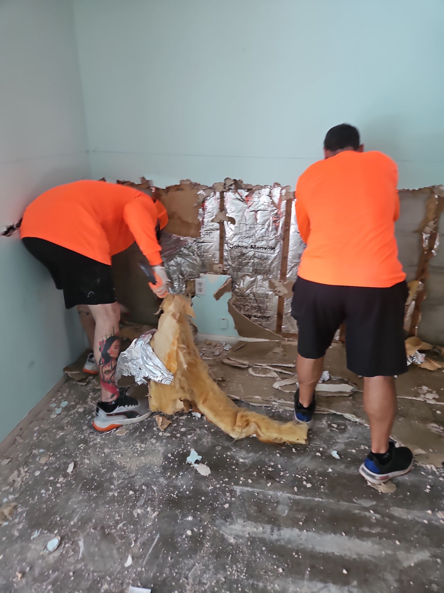 Crew removing damaged materials during interior restoration