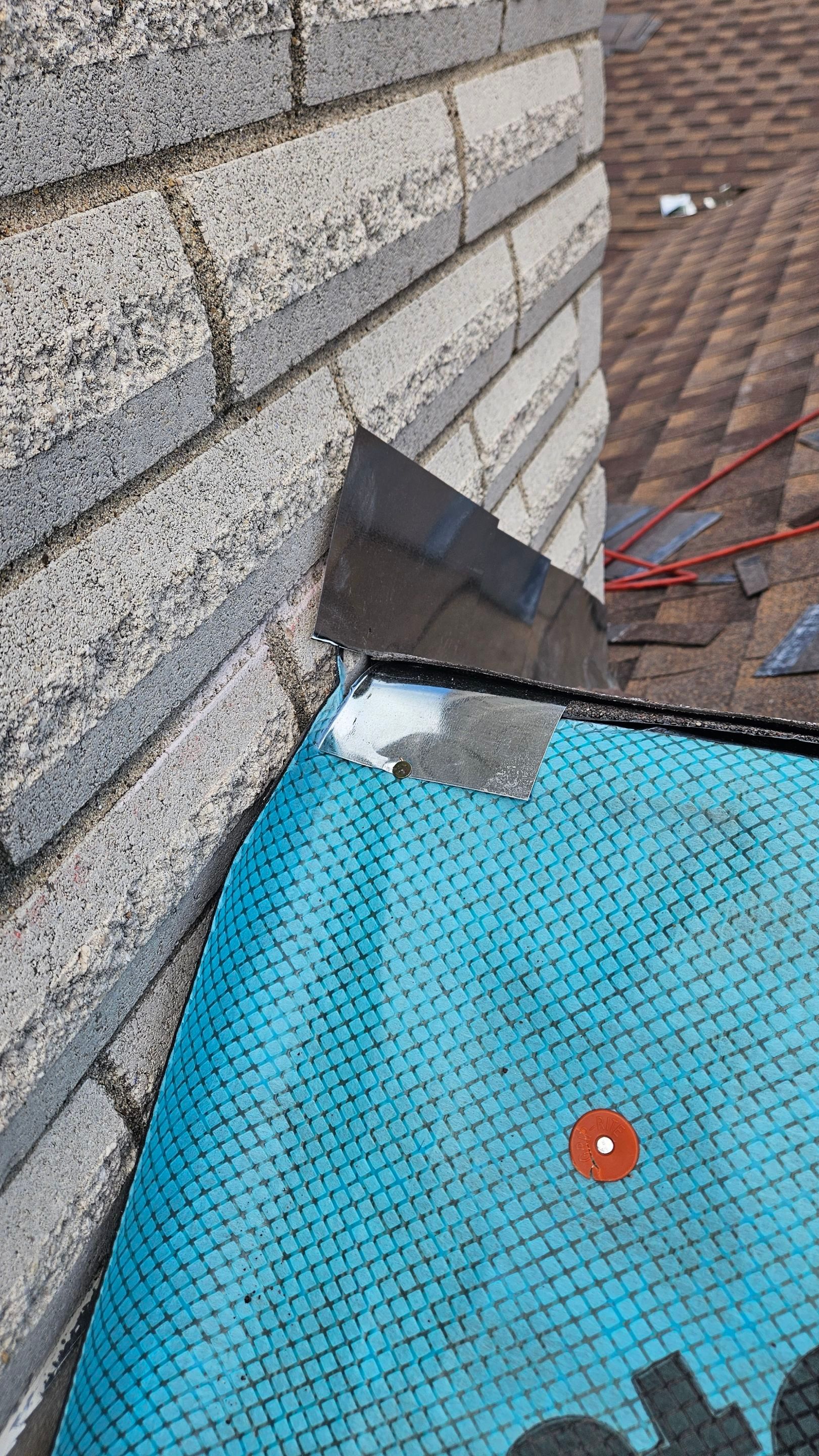 Underlayment fitted around a chimney base, Big Texas Roofing and Solar