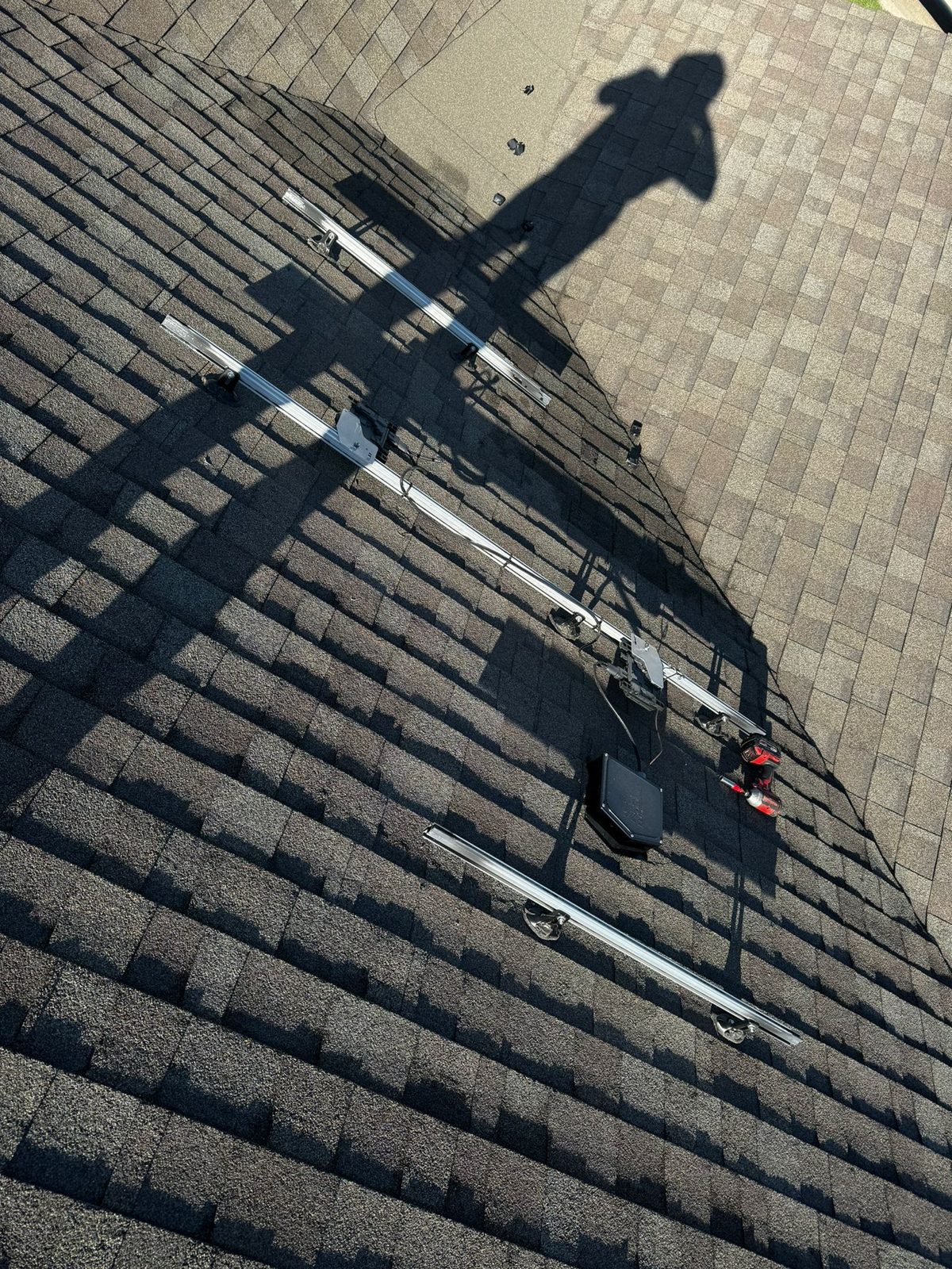 Roof attachments and rails being mounted, military veteran solar project