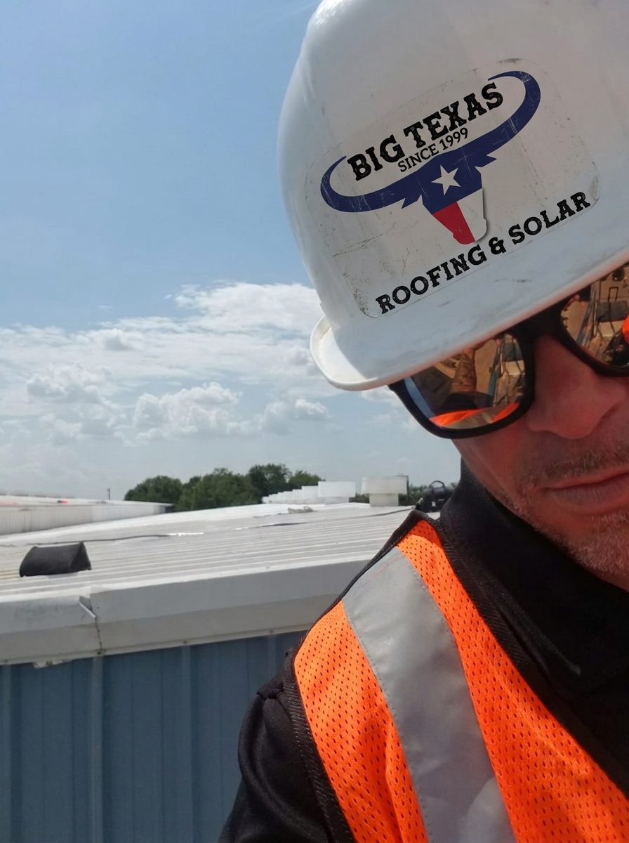 Big Texas Roofing & Solar owner on the Denver fluid applied roof in hard hat and safety vest