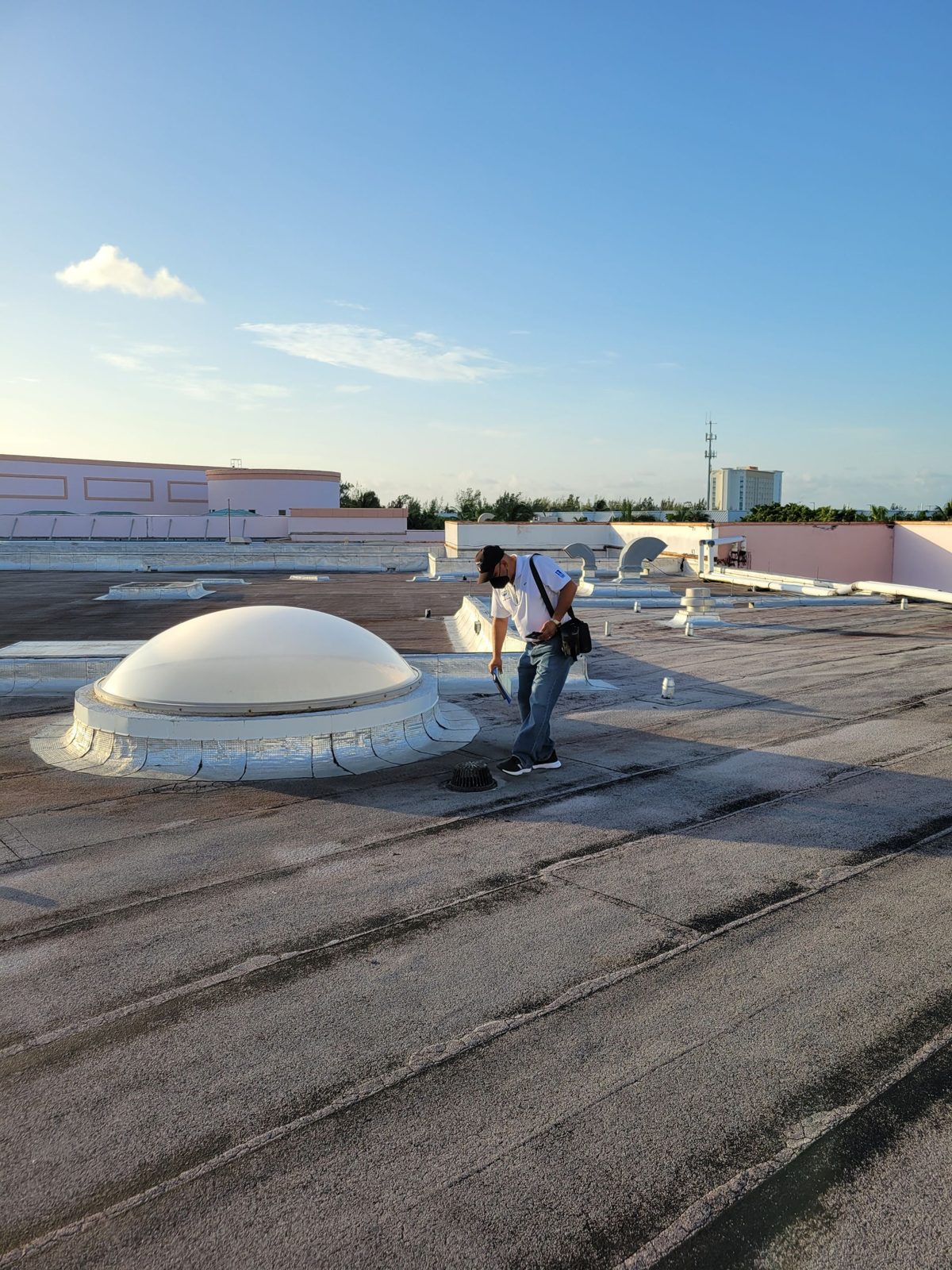 Inspector reviewing a dome skylight on a low slope roof, Atlantis Bahamas