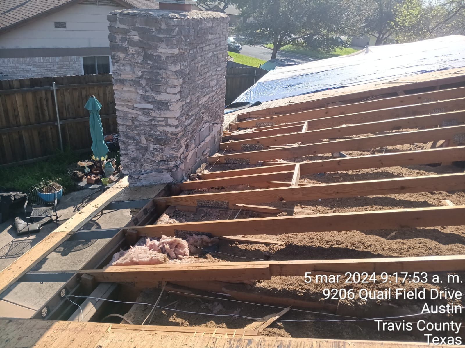 Exposed roof framing beside a chimney, Big Texas Roofing and Solar