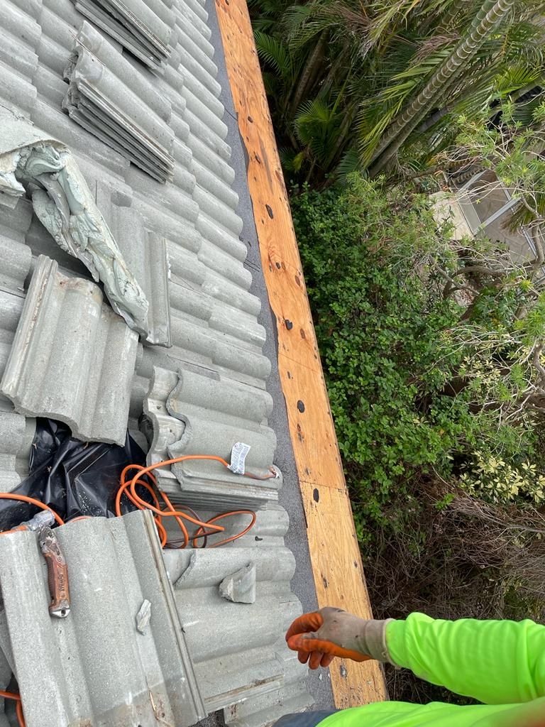 Roof edge decking exposed beside concrete tiles, Big Texas Roofing and Solar